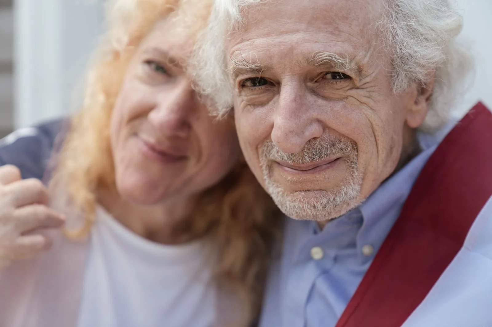 A happy senior couple smiling together outdoors